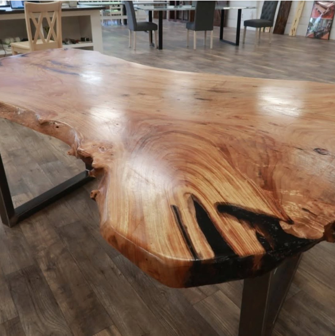 Live edge wood slab table with black epoxy detail