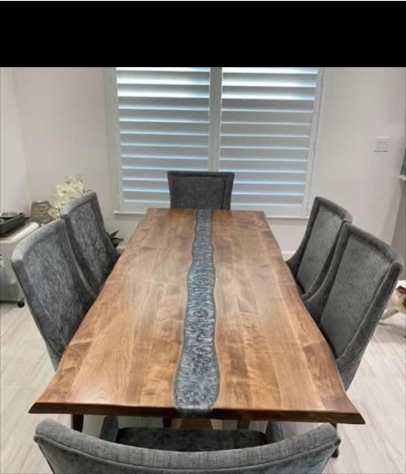 Walnut dining table with silver epoxy river in a customer home